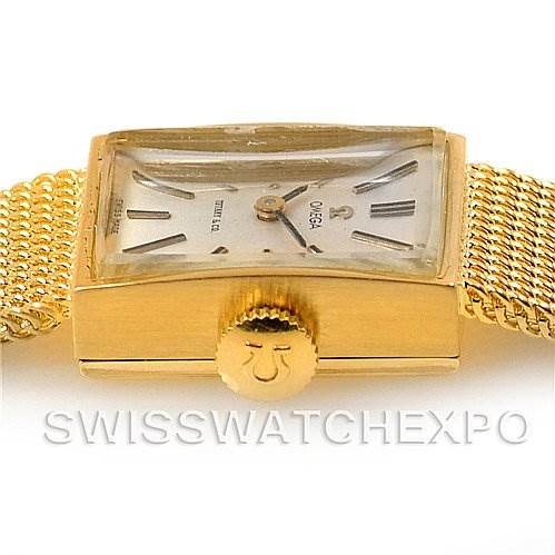 The image shows a side view of a Vintage Ladies 14k Yellow Gold Watch Made For Tiffany by Omega Women's Yellow Gold Silver Dial Women's Yellow Gold Silver Dial, highlighting the crown and part of the mesh band.