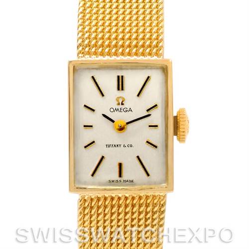 The image shows a front view of the Omega Women's Yellow Gold Silver Dial Women's Yellow Gold Silver Dial Vintage Ladies 14k Yellow Gold Watch Made For Tiffany, highlighting the face, crown, and textured band.