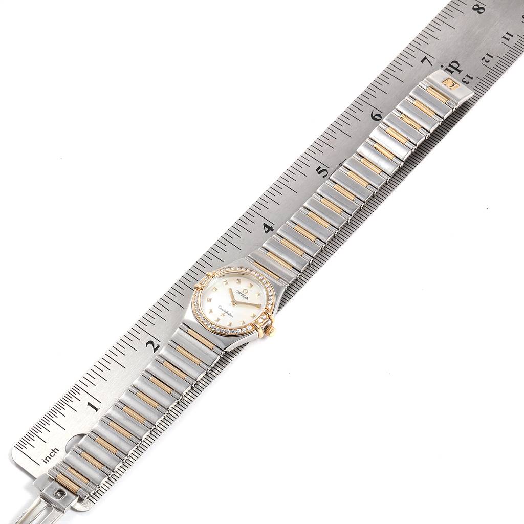 The image shows an Omega 1376.71.00 Women's Steel and Gold (two tone) Mother of Pearl Dial 1376.71.00 Women's Steel and Gold (two tone) Mother of Pearl Dial Constellation My Choice Steel Yellow Gold Diamond Watch 1376.71.00 laid flat next to a ruler for measurement.