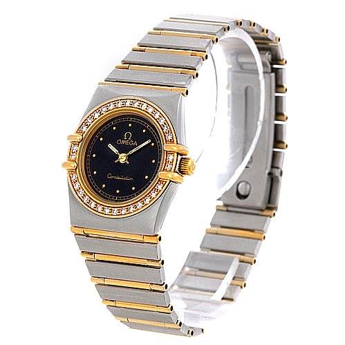The image shows the Omega 1267.10.00 Women's Steel and Gold (two tone) Black Dial 1267.10.00 Women's Steel and Gold (two tone) Black Dial Constellation Diamond Mini 1267.10.00 watch at a three-quarter angle, highlighting its face and bracelet.