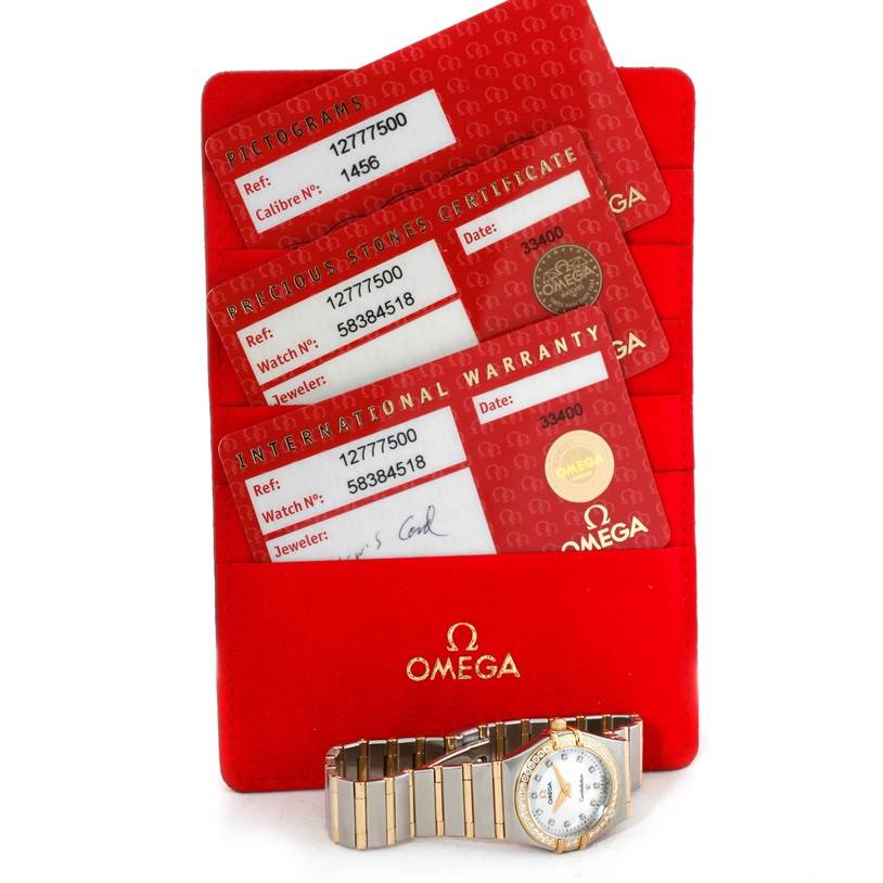 The image shows the Omega 1277.75.00 Women's Steel and Gold (two tone) Mother of Pearl Dial 1277.75.00 Women's Steel and Gold (two tone) Mother of Pearl Dial Constellation My Choice Steel Gold Diamond Watch 1277.75.00 with warranty cards and certificates.