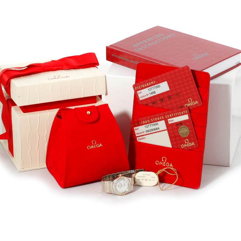 The Constellation My Choice Steel Gold Diamond Watch 1277.70.00 by Omega 1277.70.00 Women's Steel and Gold (two tone) Mother of Pearl Dial 1277.70.00 Women's Steel and Gold (two tone) Mother of Pearl Dial is displayed with its box, red pouch, cards, and manual.