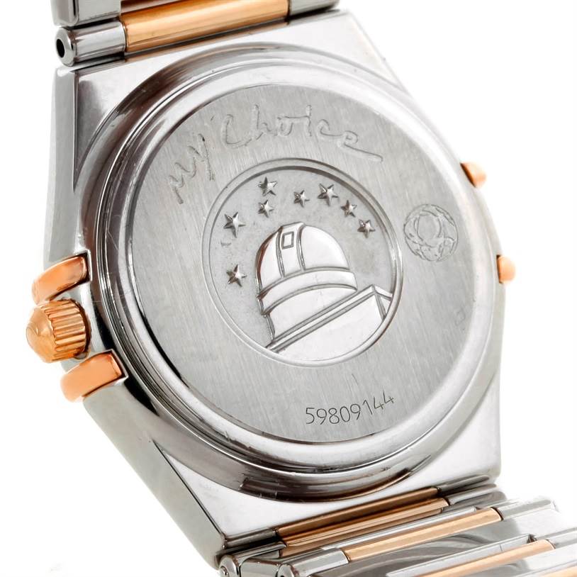 The image shows the case back and part of the bracelet of the Omega 1358.79.00 Women's Steel and Gold (two tone) Mother of Pearl Dial 1358.79.00 Women's Steel and Gold (two tone) Mother of Pearl Dial Constellation Iris Steel Rose Gold Multi Stone Watch 1358.79.00 model.