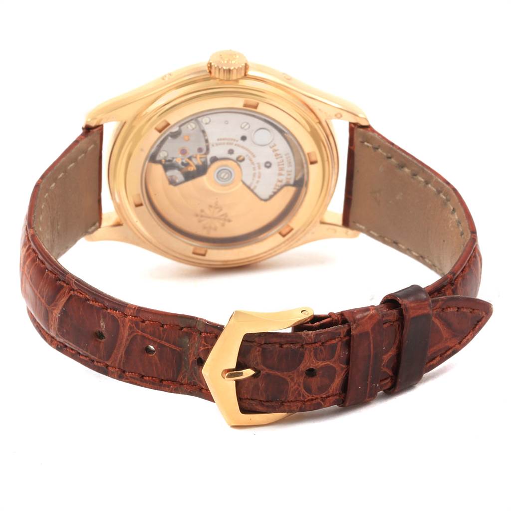 The image shows the back view of a Patek Philippe 5035J Men's Yellow Gold Silver Dial 5035J Men's Yellow Gold Silver Dial 5035 Complicated Annual Calendar Yellow Gold Men's Watch, highlighting its movement and leather strap.