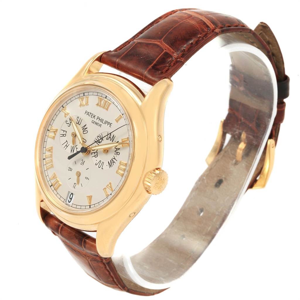 The image shows a side view of the Patek Philippe 5035J Men's Yellow Gold Silver Dial 5035J Men's Yellow Gold Silver Dial Complicated Annual Calendar Yellow Gold Men's Watch 5035, highlighting its dial and leather strap.