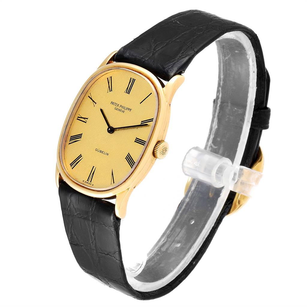 The image shows a Patek Philippe Golden Ellipse 3846 Men's Yellow Gold Champagne Dial 3846 Men's Yellow Gold Champagne Dial watch at a slight angle, highlighting its gold case, dial, black strap, and crown.
