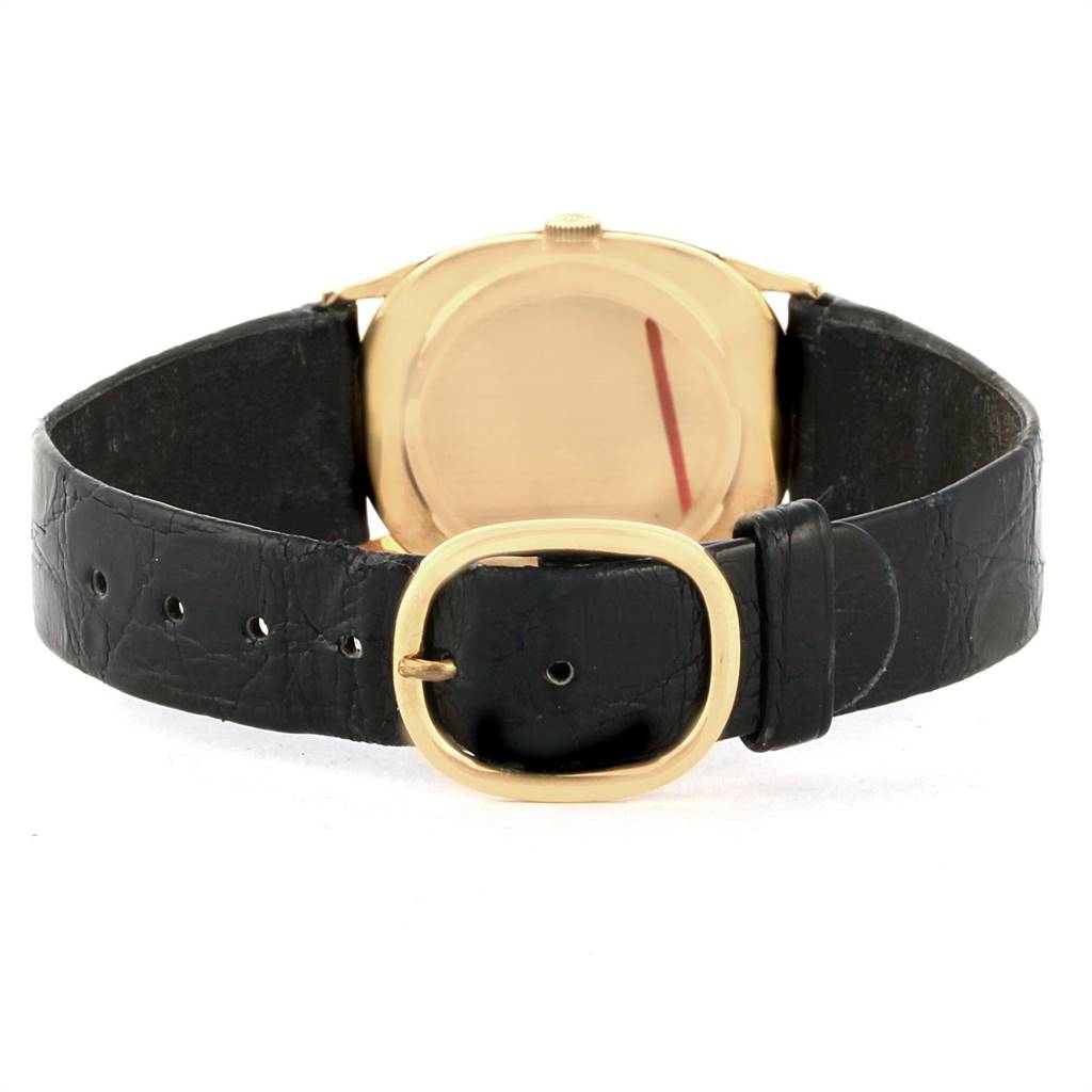 The image shows the back view of a Patek Philippe Golden Ellipse 3846 Men's Yellow Gold Champagne Dial 3846 Men's Yellow Gold Champagne Dial watch, highlighting the case and black leather strap with a gold buckle.