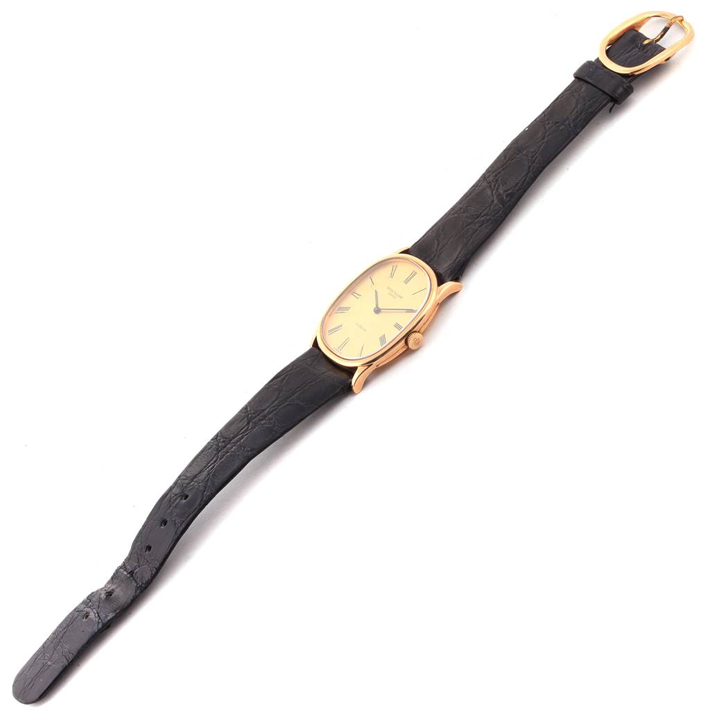 This image shows a top-down view of the Patek Philippe Golden Ellipse 3846 Men's Yellow Gold Champagne Dial 3846 Men's Yellow Gold Champagne Dial watch, highlighting its dial, case, crown, strap, and buckle.