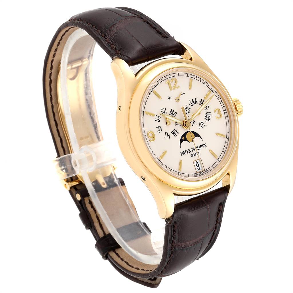 The Patek Philippe 5146J Men's Yellow Gold Beige Dial 5146J Men's Yellow Gold Beige Dial Complicated Annual Calendar Yellow Gold Men's Watch 5146J is shown from a front angle, displaying its face and leather strap.