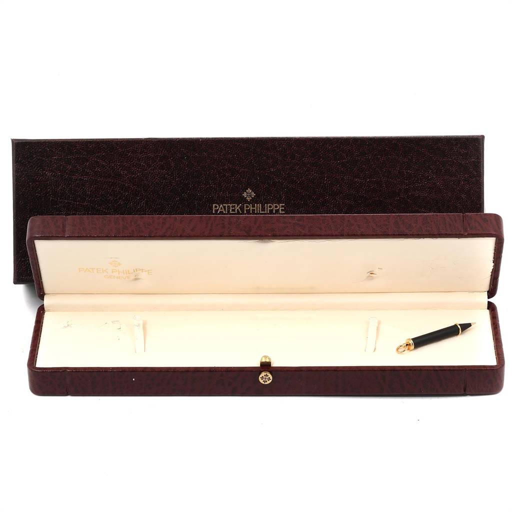 The image shows the open box and pen accessory of the Patek Philippe 5146J Men's Yellow Gold Beige Dial 5146J Men's Yellow Gold Beige Dial Complicated Annual Calendar Yellow Gold Men's Watch 5146J model.