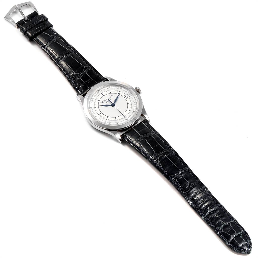 The image shows a top-down view of a Patek Philippe Calatrava 5296G Men's White Gold Silver Dial 5296G Men's White Gold Silver Dial watch, including the dial, case, and leather strap.