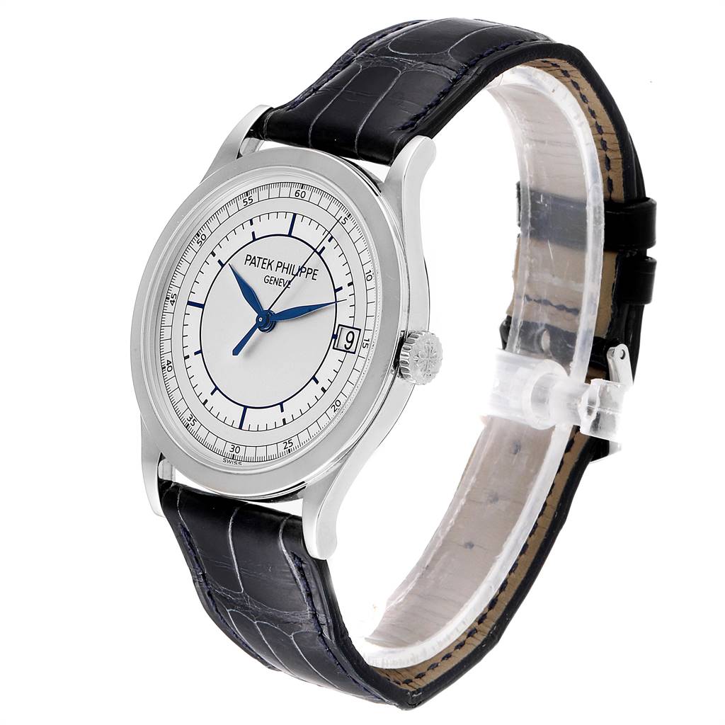 The image shows a side angle of a Patek Philippe Calatrava 5296G Men's White Gold Silver Dial 5296G Men's White Gold Silver Dial watch featuring its dial, crown, and leather strap.