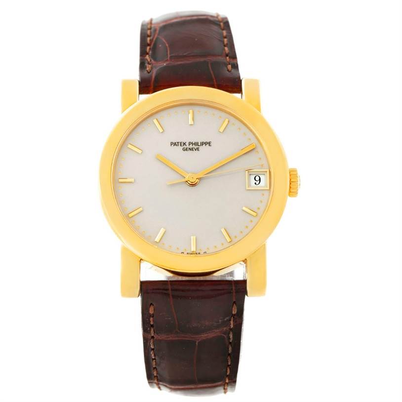 The image shows a front view of the Patek Philippe Calatrava 5012 Men's Yellow Gold Beige Dial 5012 Men's Yellow Gold Beige Dial watch, highlighting its golden case, cream dial, and brown leather strap.