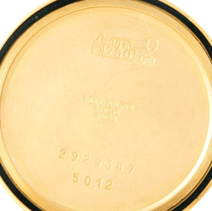 The image shows the inside of the case back of a Patek Philippe Calatrava 5012 Men's Yellow Gold Beige Dial 5012 Men's Yellow Gold Beige Dial model, displaying hallmarks and serial numbers.