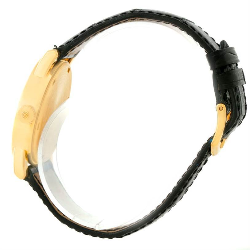 This side view of the Patek Philippe Calatrava 5012 Men's Yellow Gold Beige Dial 5012 Men's Yellow Gold Beige Dial watch shows the gold case and black leather strap with buckle.