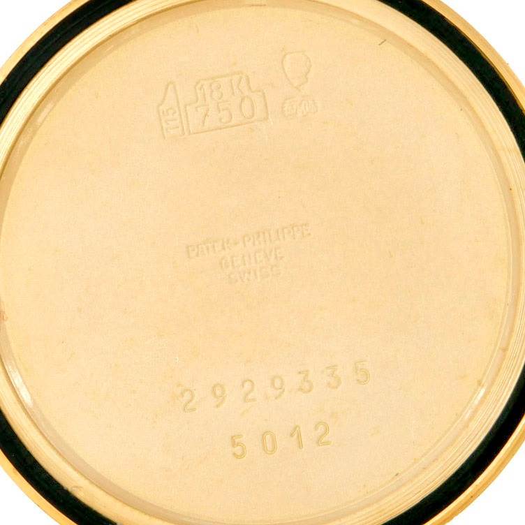 This image shows the inner back cover of a Patek Philippe Calatrava 5012 Men's Yellow Gold Beige Dial 5012 Men's Yellow Gold Beige Dial watch model, with hallmarks and serial numbers visible.