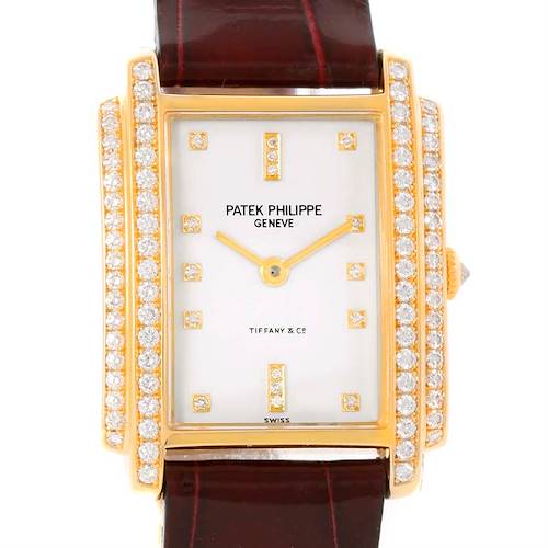 The image shows a front view of a Patek Philippe Gondolo 4825/100 Women's Yellow Gold White Dial 4825/100 Women's Yellow Gold White Dial watch, featuring a rectangular face with diamond accents and a leather strap.