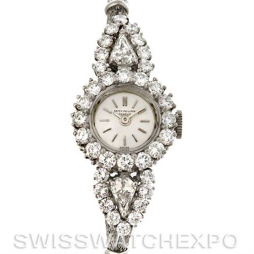 The image shows a vintage Patek Philippe watch face surrounded by diamonds, viewed from the front angle.