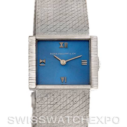 This image shows a frontal view of a vintage Patek Philippe watch with a blue dial and textured metal strap.