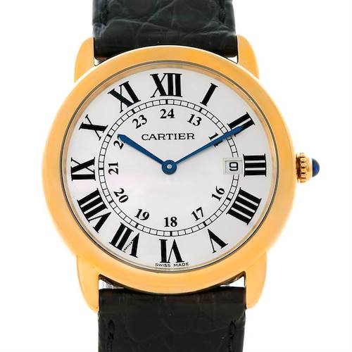 This image shows a frontal view of the Ronde model by Cartier, highlighting its gold case, Roman numeral dial, blue hands, and black leather strap.