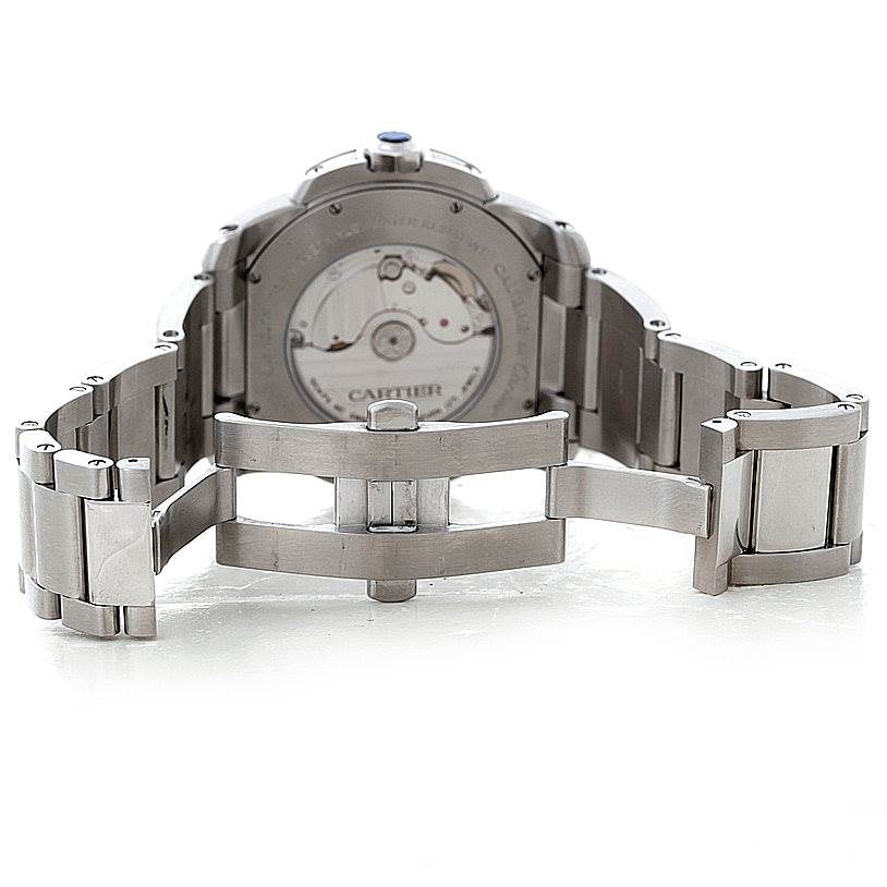 The image shows the back view of the stainless steel Calibre de Cartier watch by Cartier, displaying the open clasp and exposed movement.