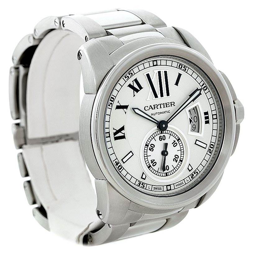 The image shows a side and frontal view of the Calibre de Cartier watch by Cartier, highlighting the dial, bezel, and part of the bracelet.