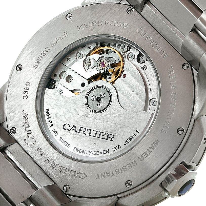The image shows the back view of the Calibre de Cartier watch by Cartier, focusing on its automatic movement mechanism.