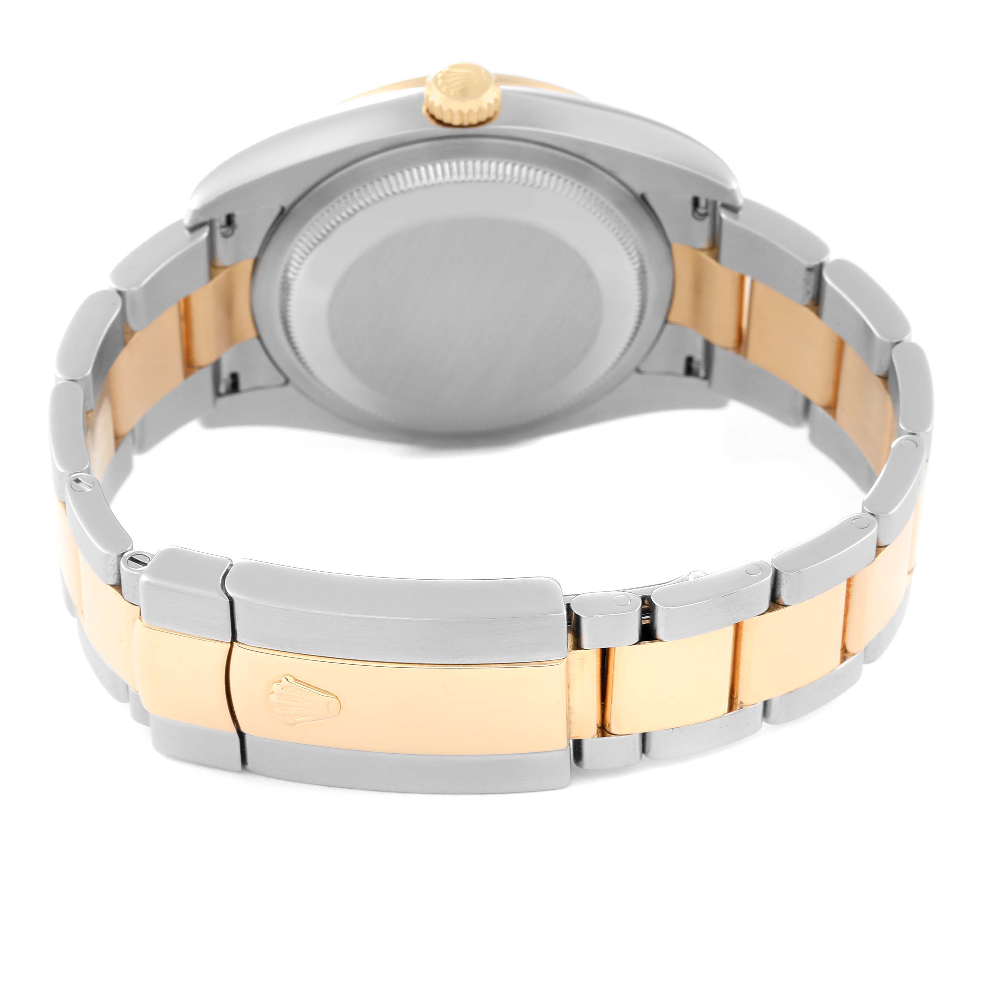 The image shows the back case and bracelet of a Rolex Datejust 116243 Men's Steel and Gold (two tone) Mother of Pearl Dial 116243 Men's Steel and Gold (two tone) Mother of Pearl Dial watch, featuring a two-tone metal design with a gold crown.