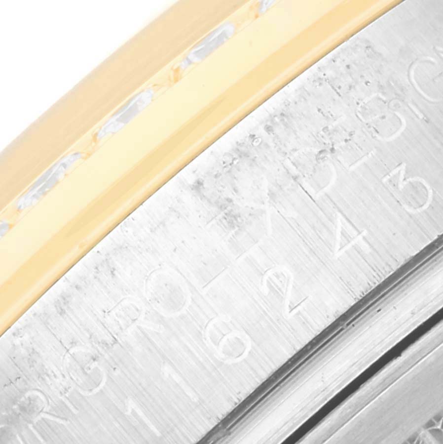 This image shows a close-up of the bezel and part of the case of a Rolex Datejust 116243 Men's Steel and Gold (two tone) Mother of Pearl Dial 116243 Men's Steel and Gold (two tone) Mother of Pearl Dial watch.