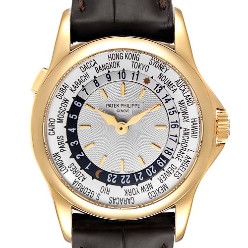 The image shows a front view of the Patek Philippe Complications 5110J Men's Yellow Gold Silver Dial 5110J Men's Yellow Gold Silver Dial watch, featuring its world time dial and gold case.