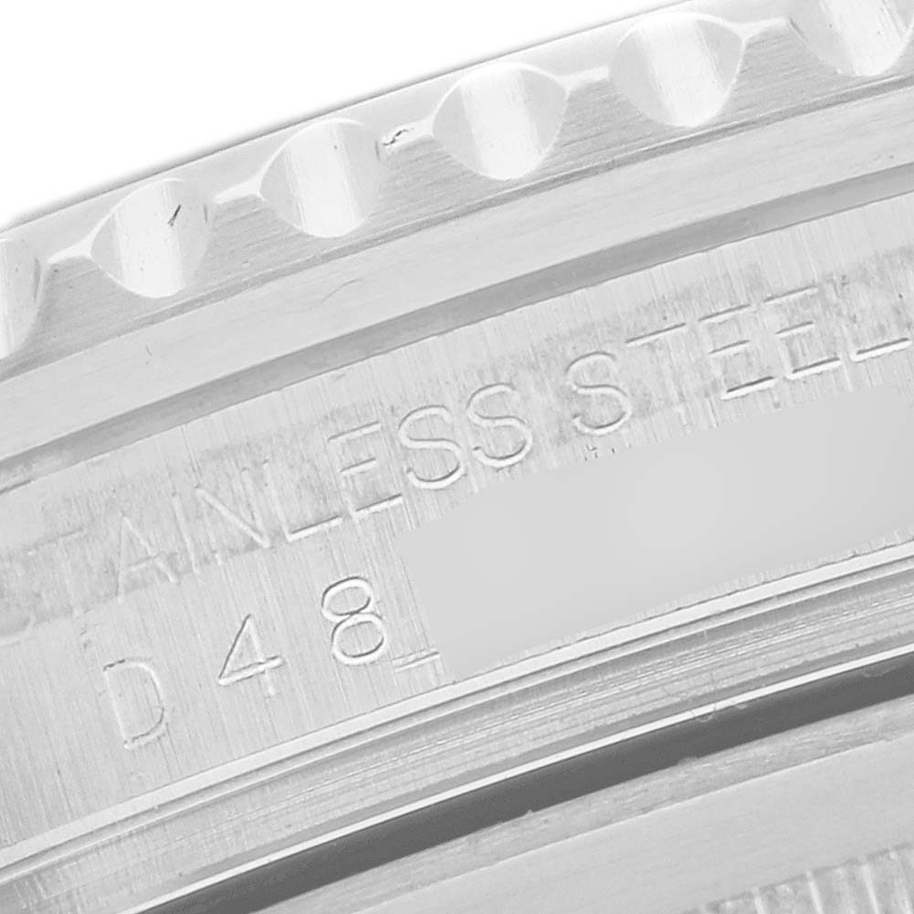 This close-up image of the Rolex GMT-Master 16710T Men's Stainless Steel Black Dial 16710T Men's Stainless Steel Black Dial shows the engraved side of the stainless steel casing.