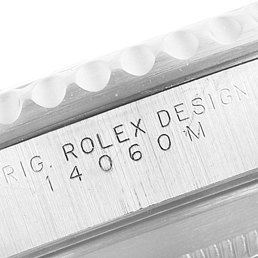 This image shows a close-up of the engraved case side of a Rolex Submariner 14060M Men's Stainless Steel Black Dial 14060M Men's Stainless Steel Black Dial model.