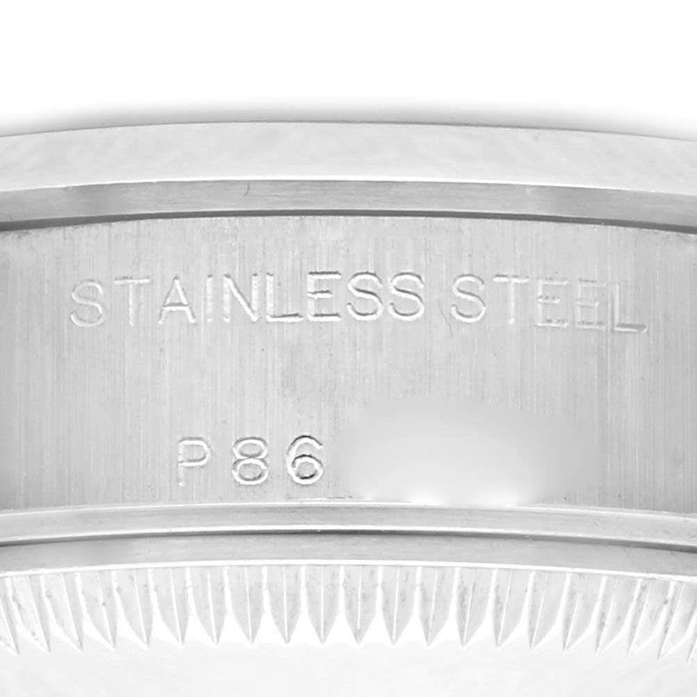 The image shows a close-up of the case back of a Rolex Date 79160 Women's Stainless Steel Blue Dial 79160 Women's Stainless Steel Blue Dial watch, highlighting the stainless steel material and serial engraving.