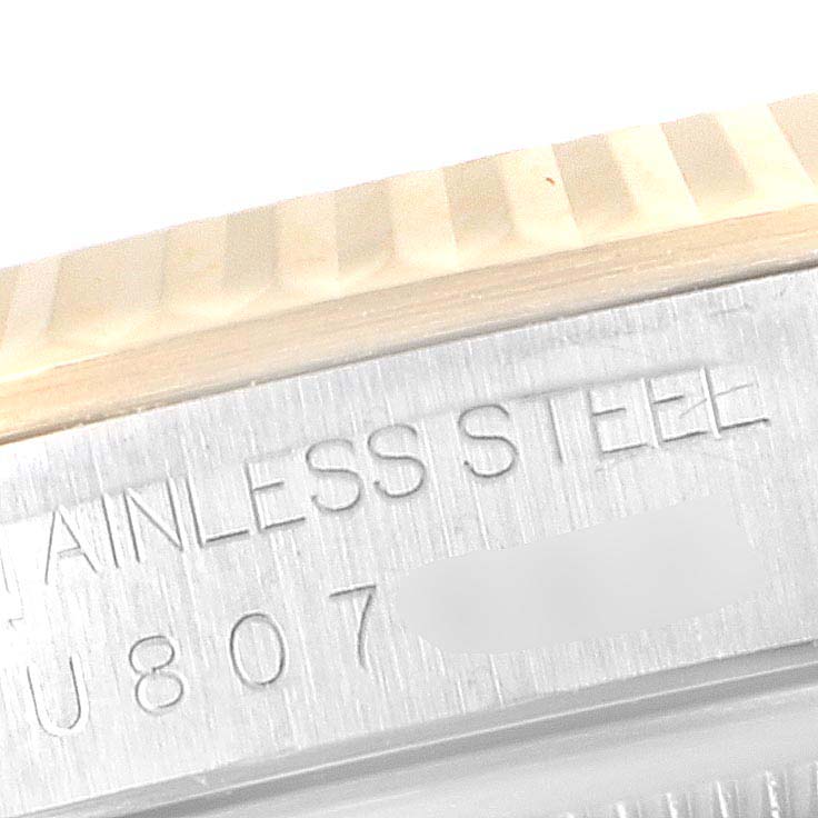 This image shows a close-up of the fluted bezel and engraving on the side of the case of a Rolex Datejust 16233 Men's Steel and Gold (two tone) Mother of Pearl Dial 16233 Men's Steel and Gold (two tone) Mother of Pearl Dial model.