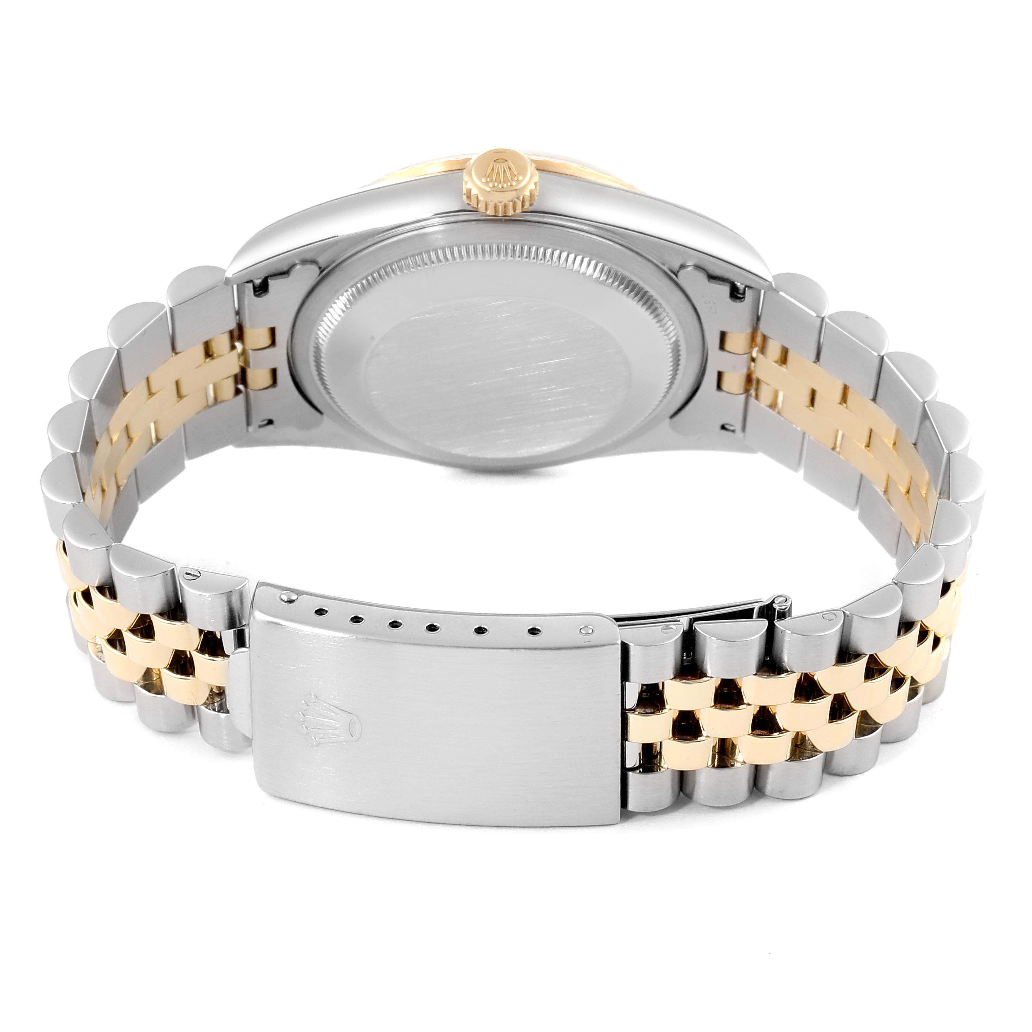 This image shows the back and clasp of a Rolex Datejust 16233 Men's Steel and Gold (two tone) Mother of Pearl Dial 16233 Men's Steel and Gold (two tone) Mother of Pearl Dial watch, highlighting its two-tone bracelet and crown.