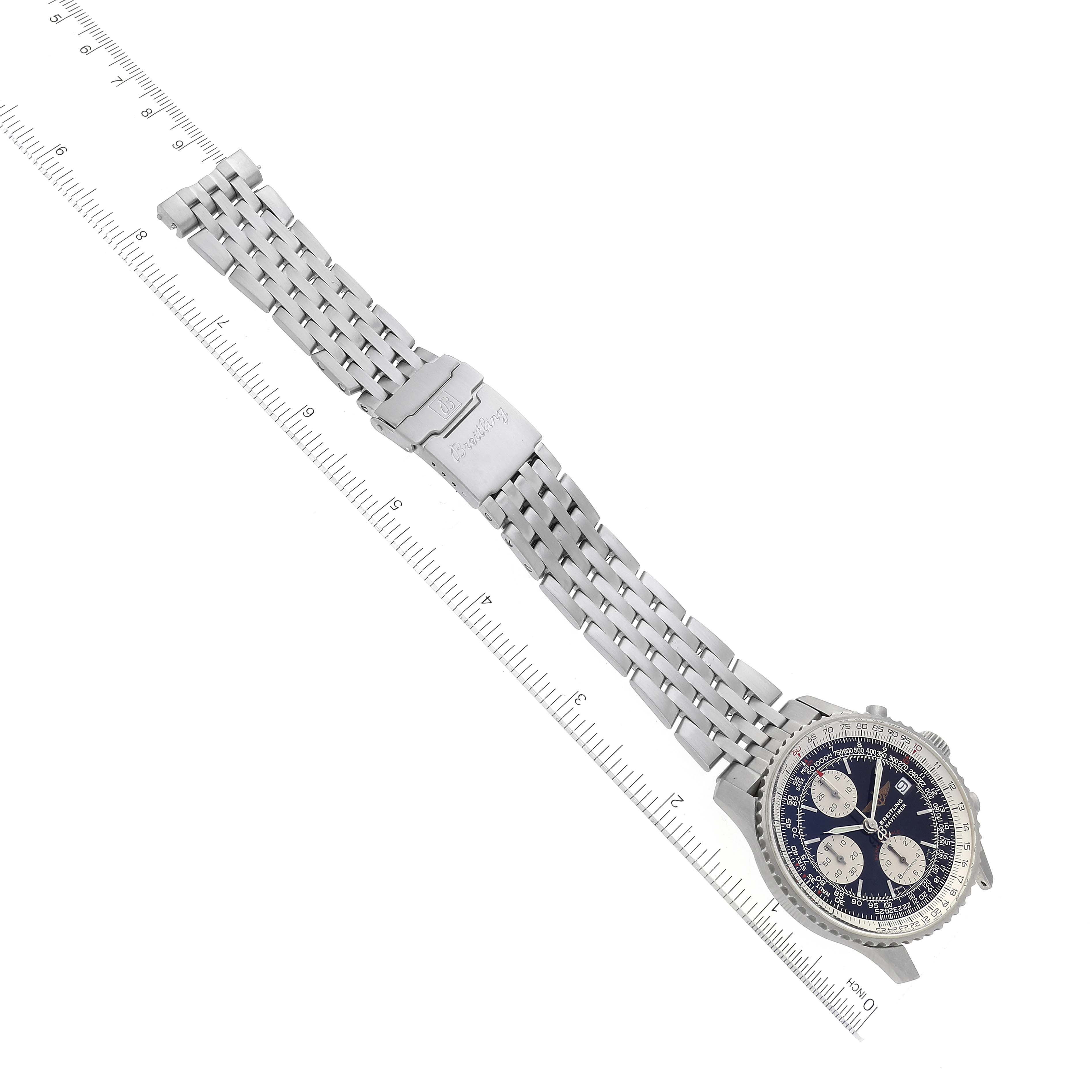 The image shows a Breitling Navitimer A13330 Men's Stainless Steel Black Dial A13330 Men's Stainless Steel Black Dial watch with a stainless steel bracelet laid flat, angled diagonally with a ruler for scale.
