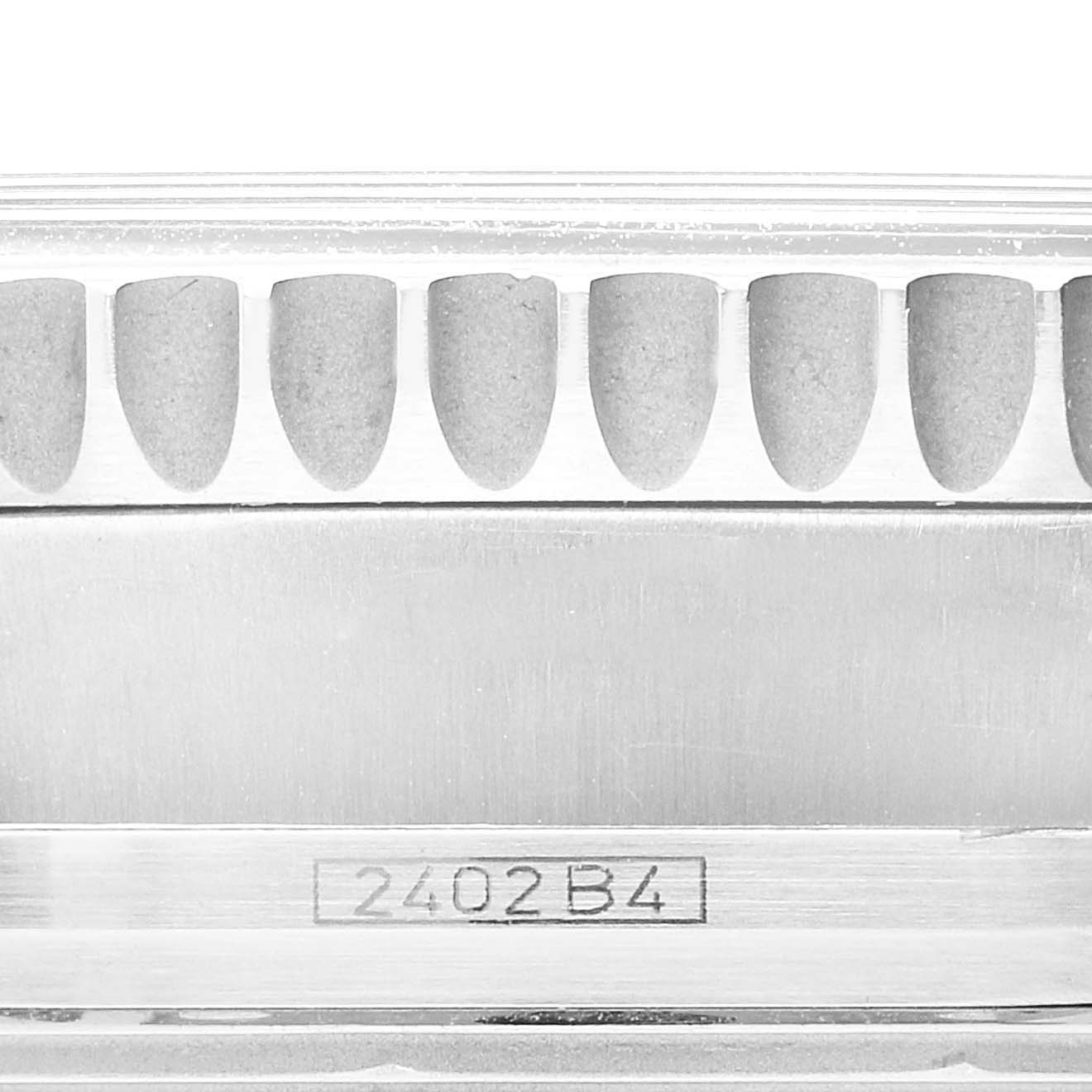 This image shows a close-up of the serial number and serrated bezel edge of a Breitling Navitimer A13330 Men's Stainless Steel Black Dial A13330 Men's Stainless Steel Black Dial watch.