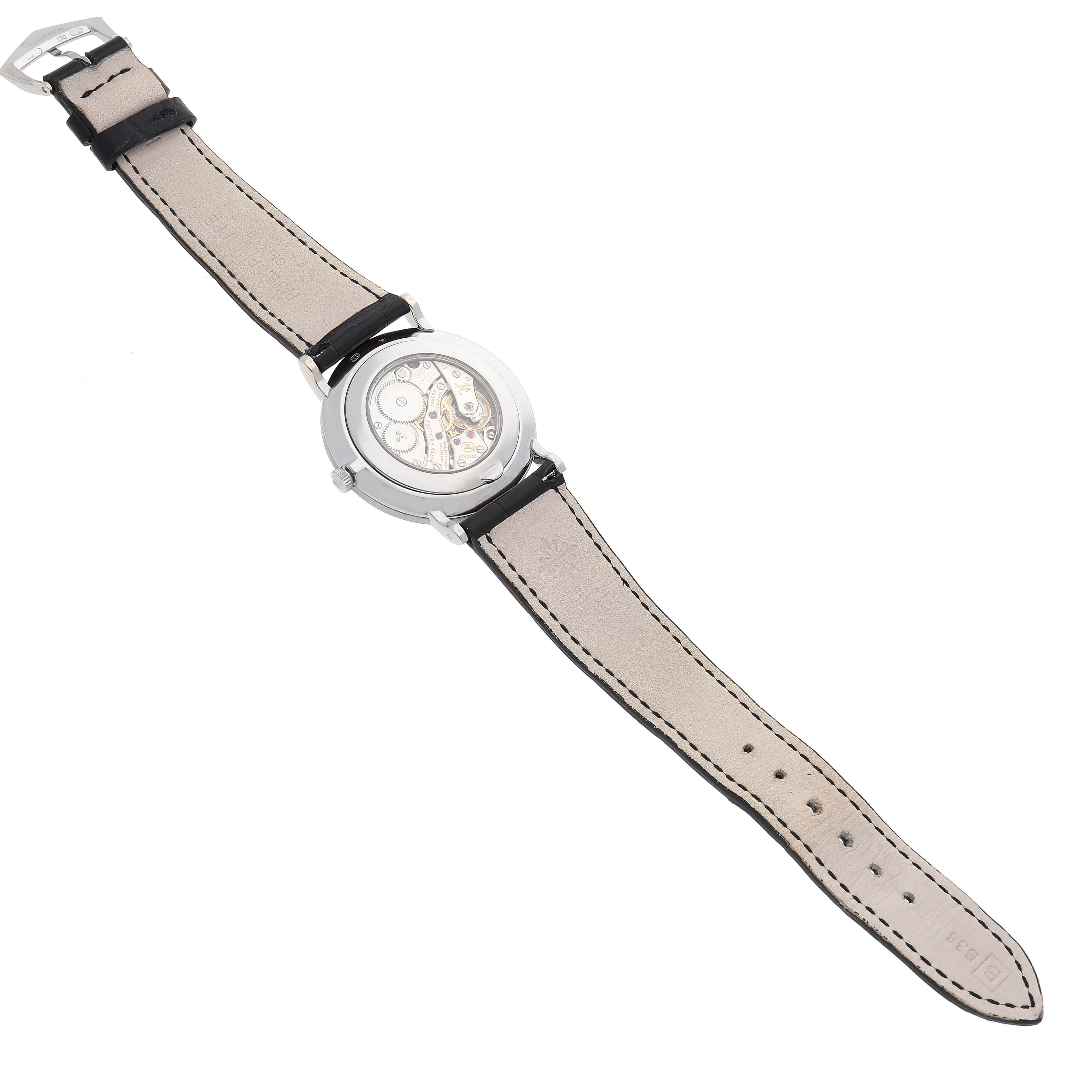 The image shows the back view of a Patek Philippe Calatrava 5119G-001 Men's White Gold White Dial 5119G-001 Men's White Gold White Dial watch, highlighting its movement and leather strap.