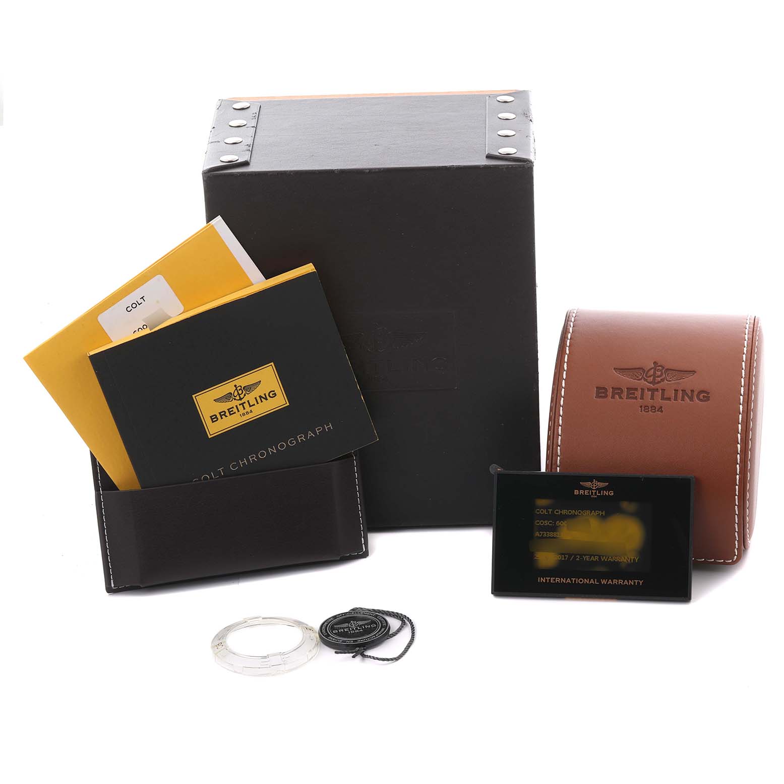 The image shows Breitling Colt A73388 Men's Stainless Steel White Dial A73388 Men's Stainless Steel White Dial watch accessories, including manuals, a black card with warranty info, a case, and packaging.