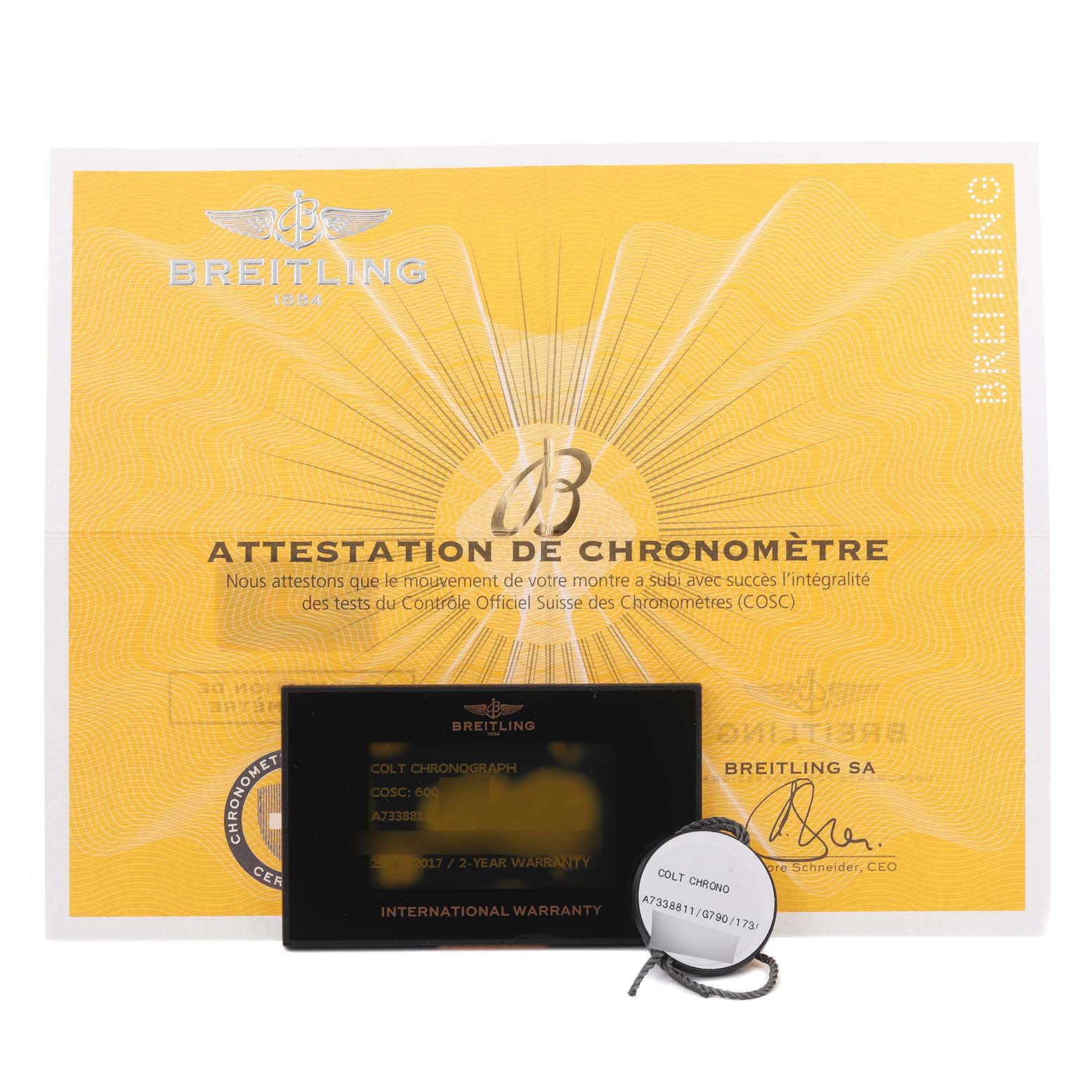 The image shows Breitling Colt A73388 Men's Stainless Steel White Dial A73388 Men's Stainless Steel White Dial model warranty card, certificate, and a tag with the watch model details.