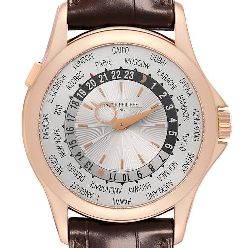 The Patek Philippe Complications 5130R-001 Men's Rose Gold Silver Dial 5130R-001 Men's Rose Gold Silver Dial watch is shown from a top-down angle, highlighting the world time display, dial, case, and brown leather strap.