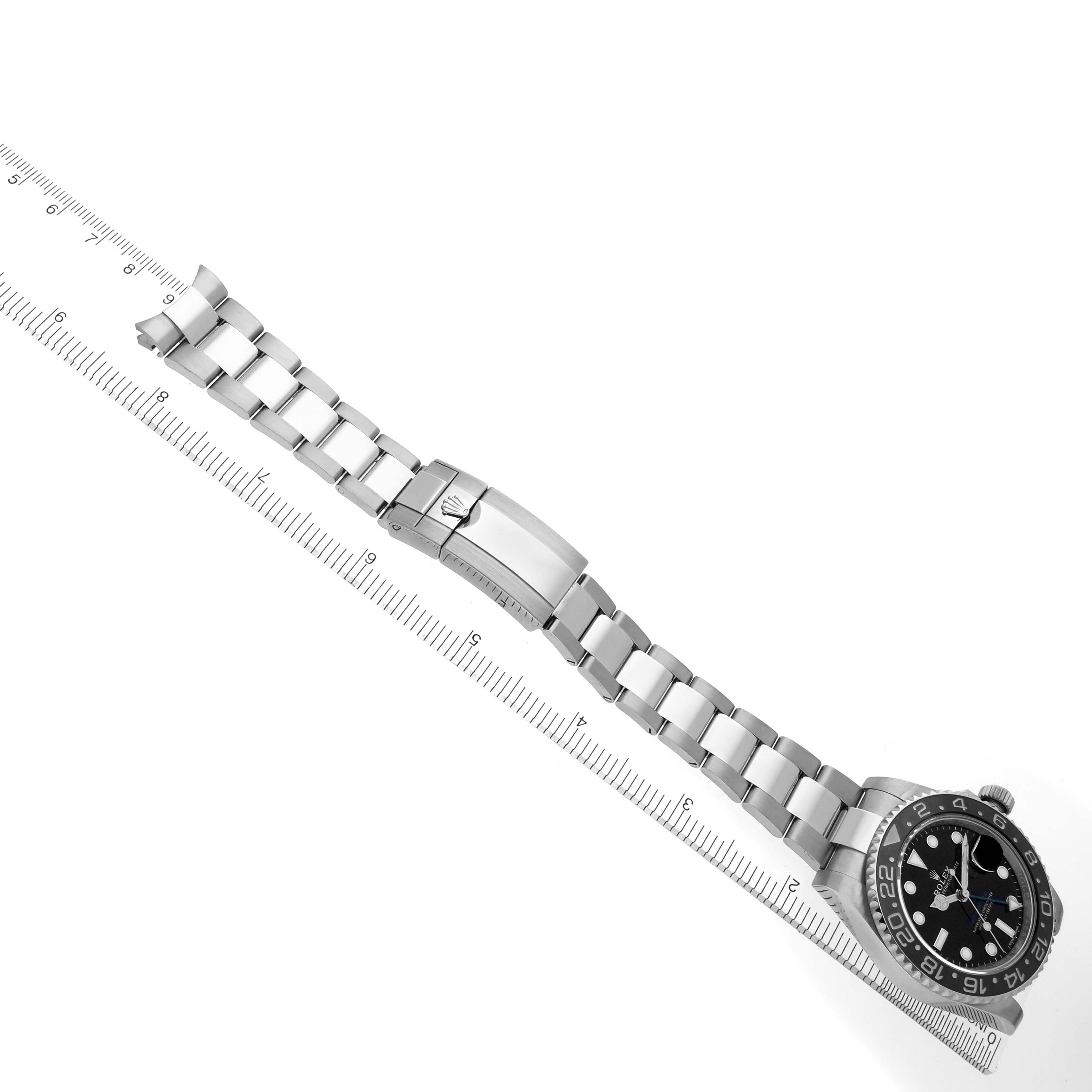The image shows a side view of the Rolex GMT-Master 116710LN Men's Stainless Steel Black Dial 116710LN Men's Stainless Steel Black Dial watch and its metal bracelet, aligned next to a ruler.