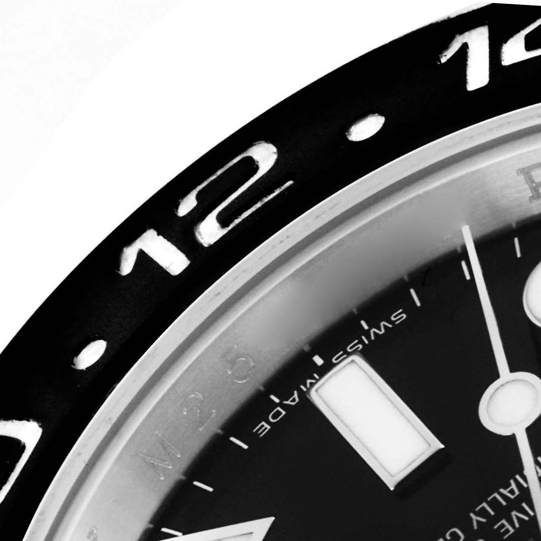 The image shows a close-up of the bezel and part of the dial of a Rolex GMT-Master 116710LN Men's Stainless Steel Black Dial 116710LN Men's Stainless Steel Black Dial watch, highlighting the 12 o'clock marker.
