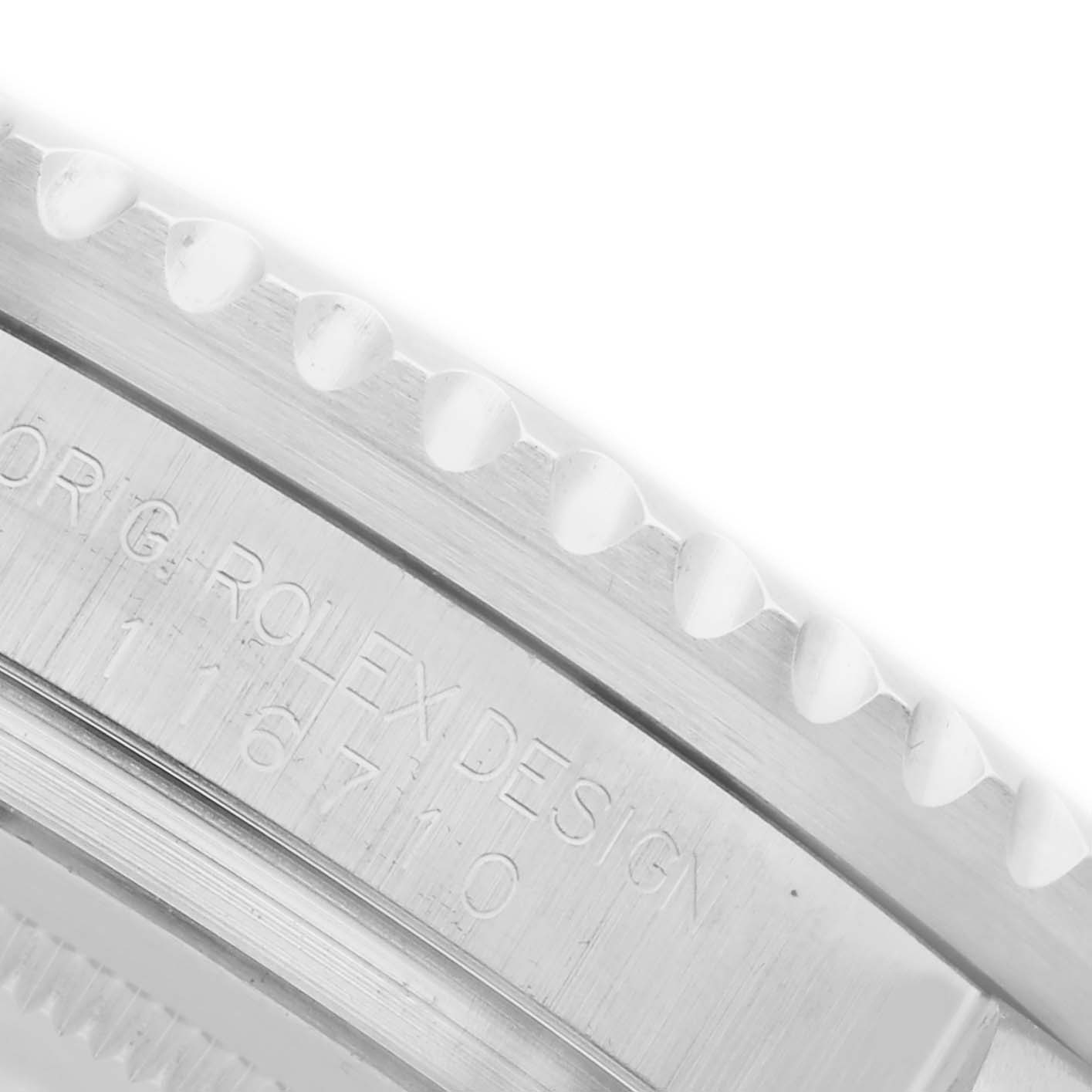 The image shows a close-up of the side and bezel edge of a Rolex GMT-Master 116710LN Men's Stainless Steel Black Dial 116710LN Men's Stainless Steel Black Dial watch, displaying the engraved model number.