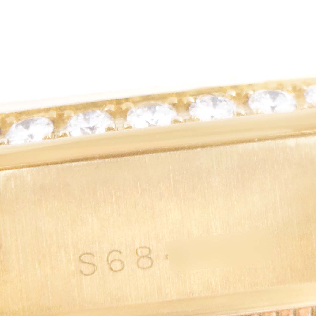 This close-up image shows the bezel with diamonds and part of the watch case of a Rolex President 69268 Women's Yellow Gold Champagne Dial 69268 Women's Yellow Gold Champagne Dial model.
