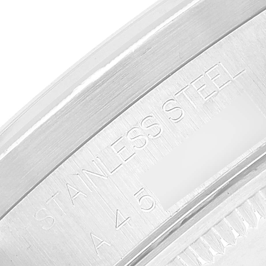 The image shows a close-up angle of the serial number and "STAINLESS STEEL" engraving on the case back of a Rolex Date 15210 Men's Stainless Steel Silver Dial 15210 Men's Stainless Steel Silver Dial model.