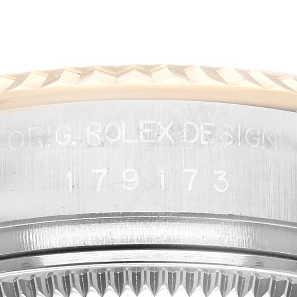 This close-up image shows the side view of the bezel and casing with the engraved serial number of a Rolex Datejust 179173 Women's Steel and Gold (two tone) Champagne Dial 179173 Women's Steel and Gold (two tone) Champagne Dial watch.