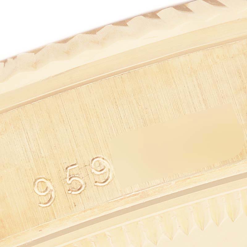 The image shows a close-up of the edge of a Rolex President 68278 Women's Yellow Gold White Dial 68278 Women's Yellow Gold White Dial model watch, focusing on the bezel and a part with engraved numbers.
