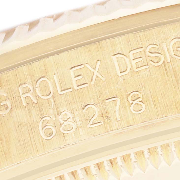 The image shows a close-up of the Rolex President 68278 Women's Yellow Gold White Dial 68278 Women's Yellow Gold White Dial model's side, highlighting its engraved model number and design markings.