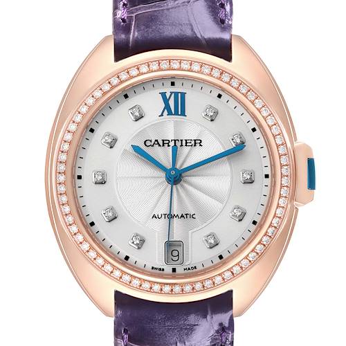 The Cartier Clé watch is shown from a front view, displaying the dial, diamond bezel, and part of the strap.